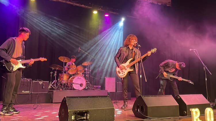 School rock band performing on stage